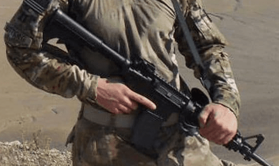 Pete Buttigieg in Afghanistan with assault rifle, cropped for fair use