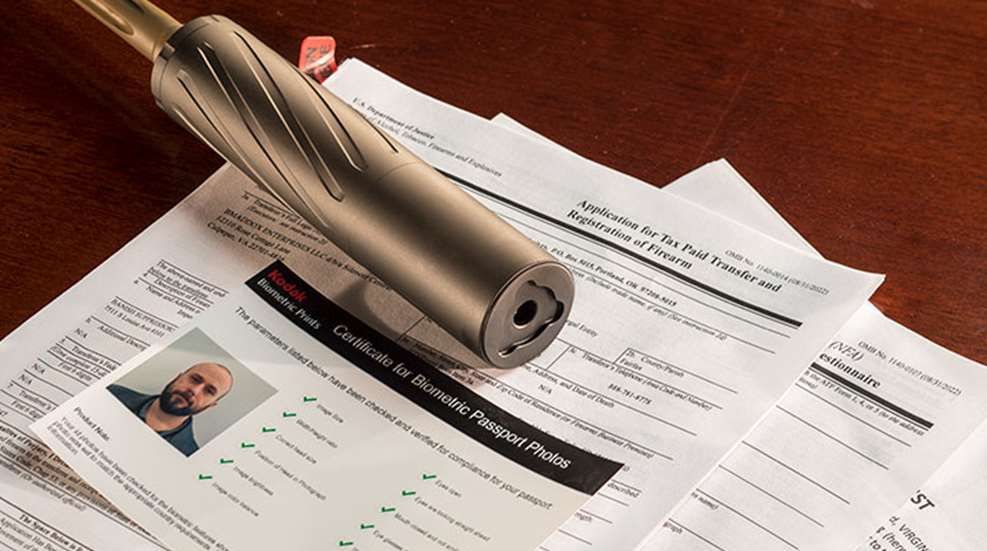 ATF Form 1 paperwork next to a suppressor representing CLEO notification removal update