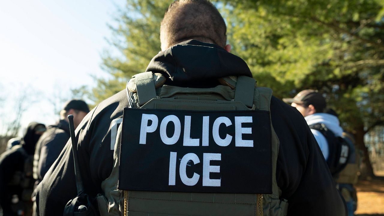 U.S. Immigration and Customs Enforcement Baltimore Field Officer listens during a briefing
