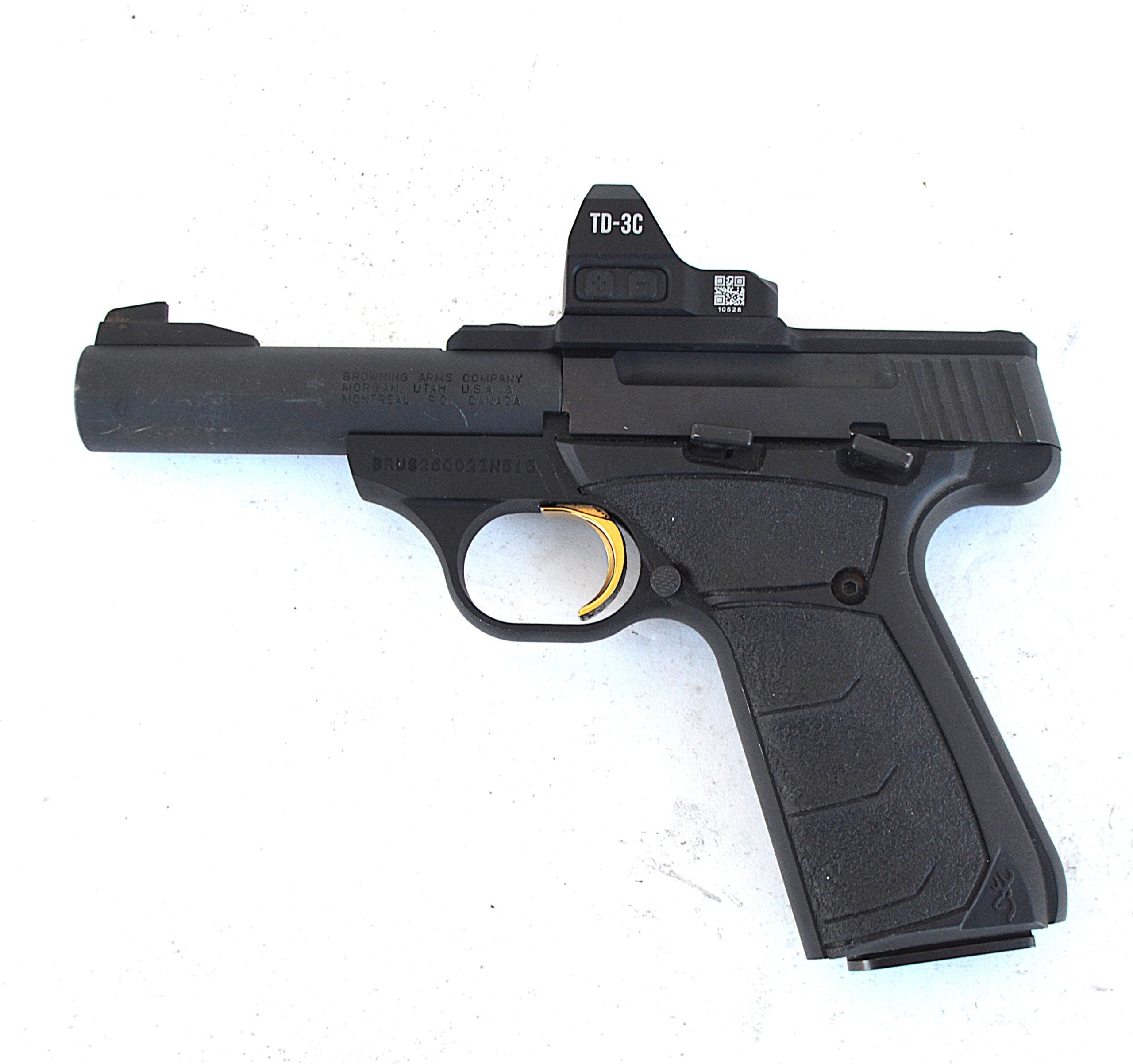 Browning Buck Mark .22 LR pistol with mounted red dot optic on a range bench used as a carry optics training handgun.