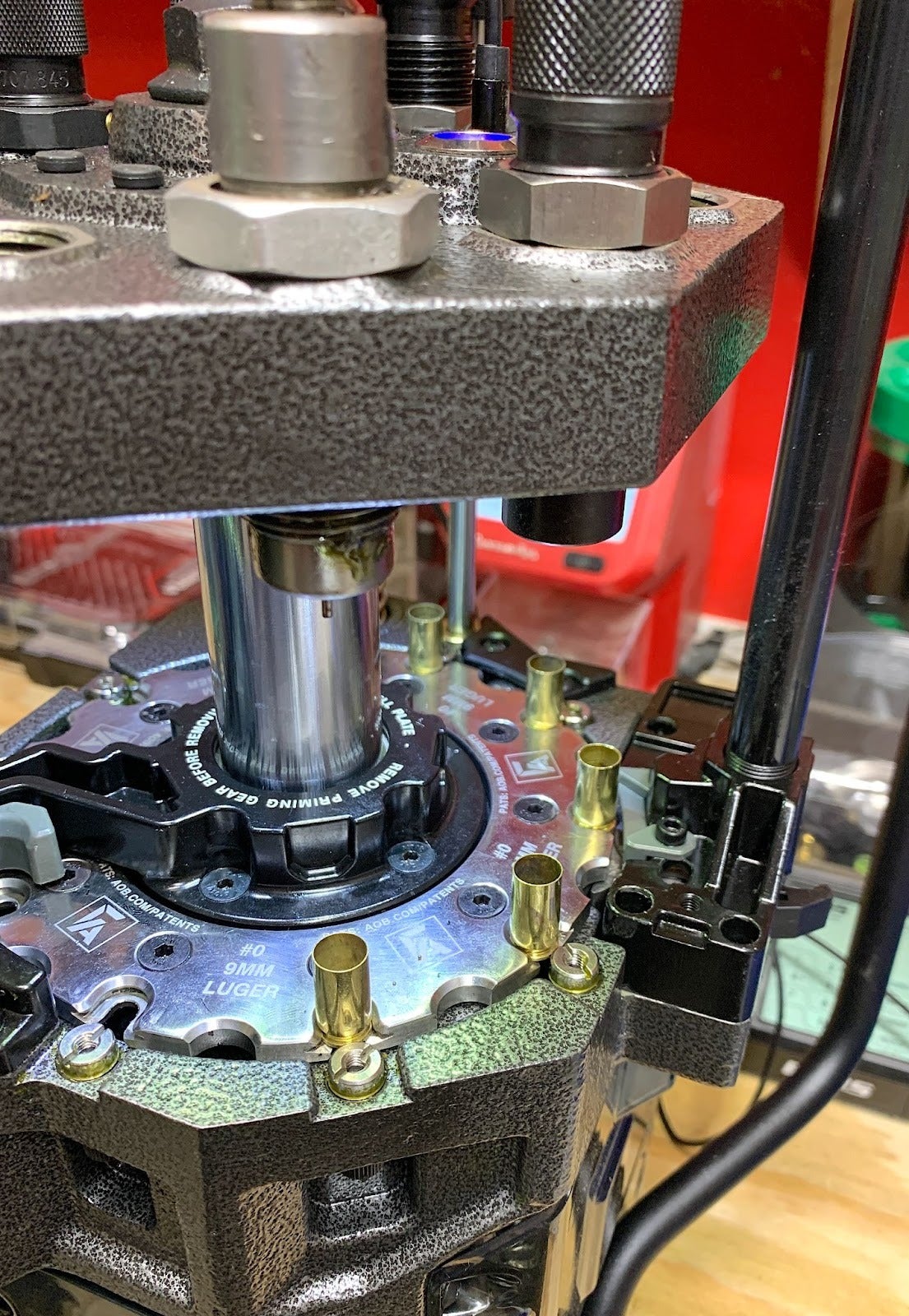 Frankford Arsenal X-10 progressive reloading press with case feeder and reloading equipment installed on bench