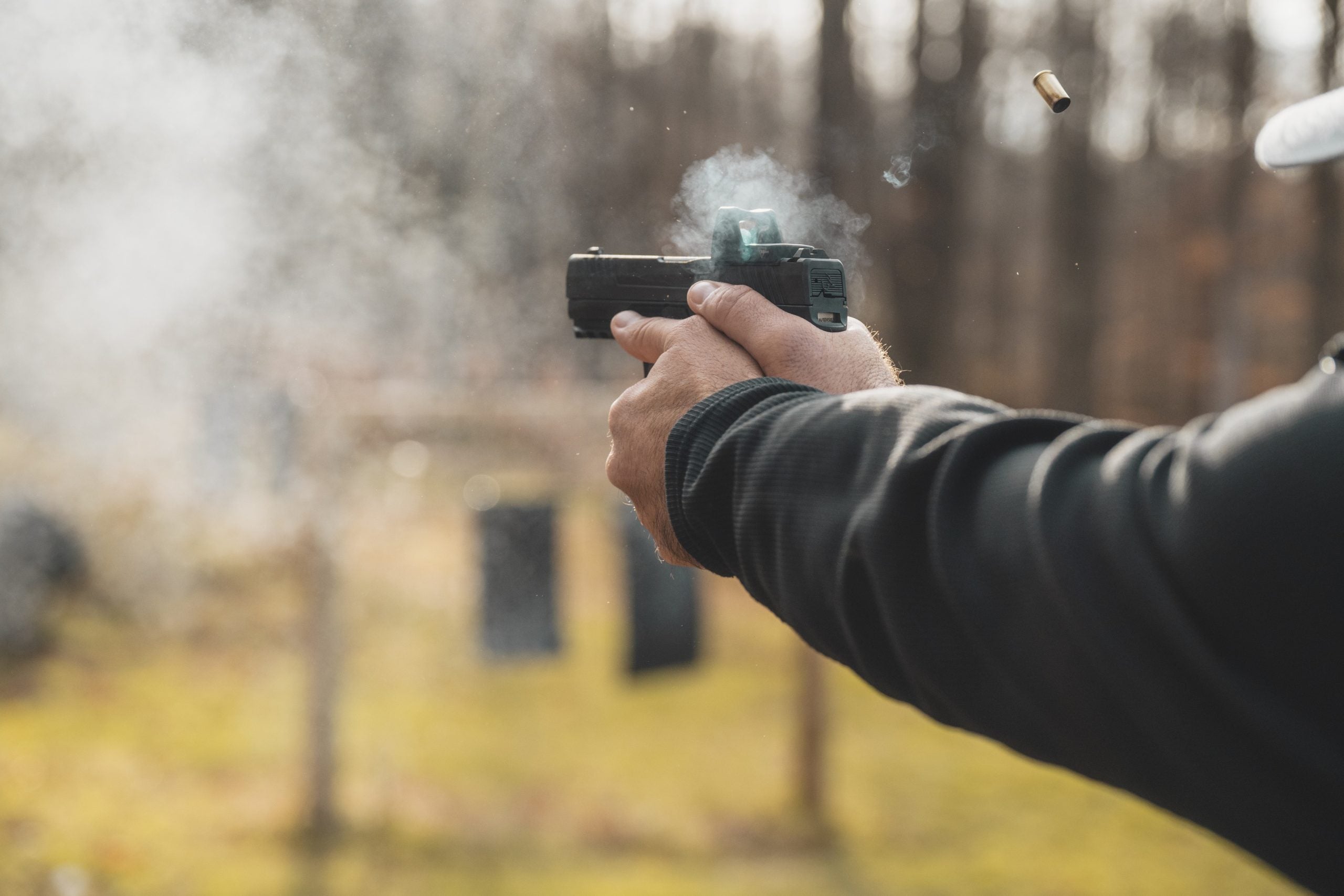 Taurus TX9 full size 9mm pistol on a range bench with loaded magazines and optics-ready slide