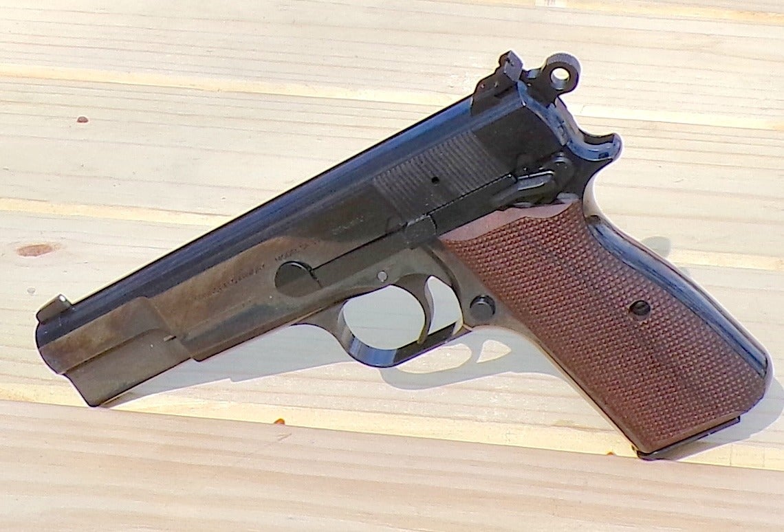 Springfield Armory SA-35 polished blue Hi-Power style 9mm pistol photographed at outdoor range