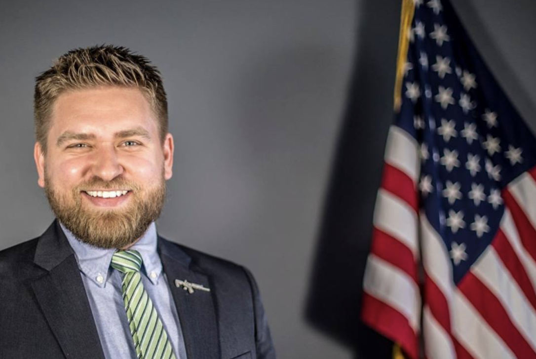Chris McNutt, TXGR president next to an American Flag.
