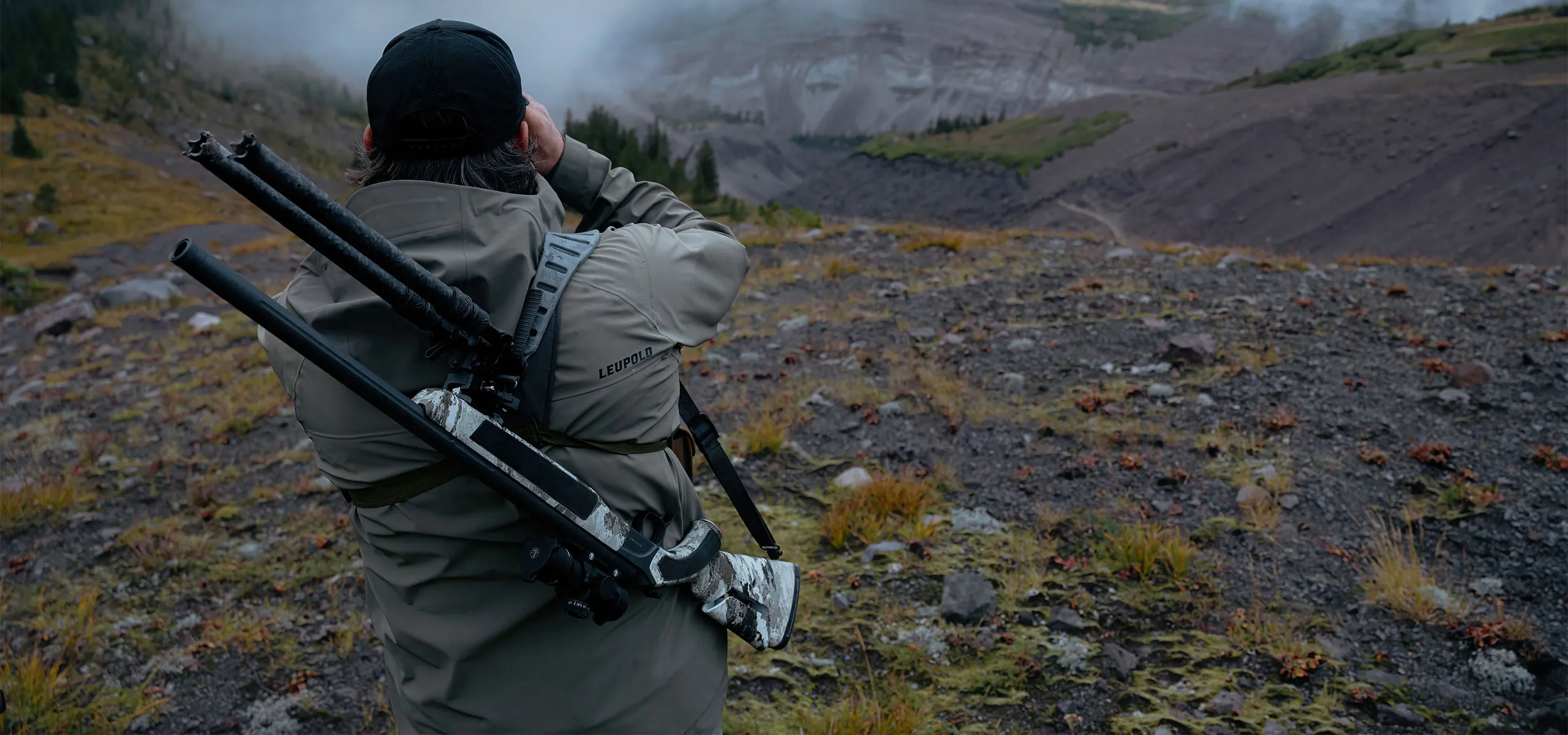 Hunter wearing Leupold Storm Warden rain jacket and pants outdoors