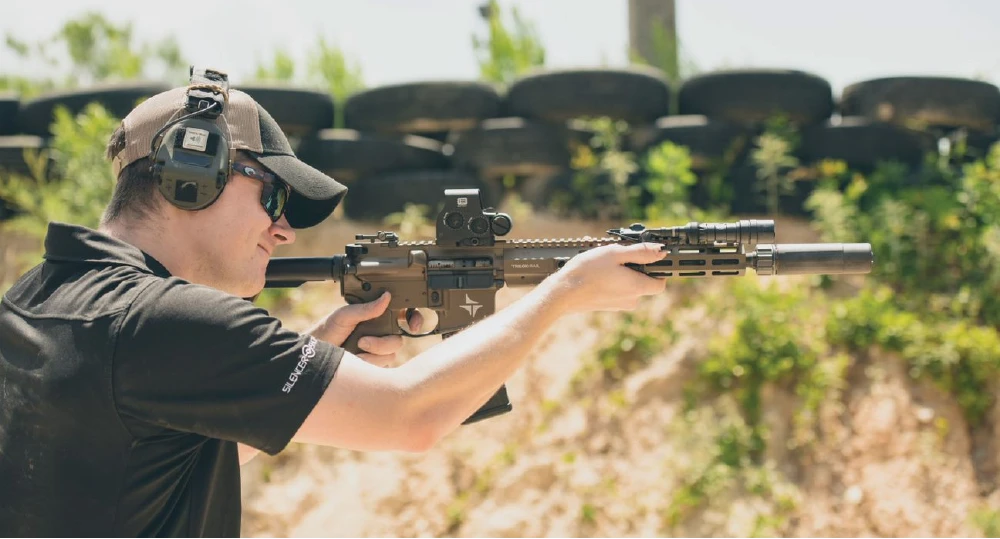 Suppressor mounted on a rifle explaining NFA rules for letting someone else use your suppressor
