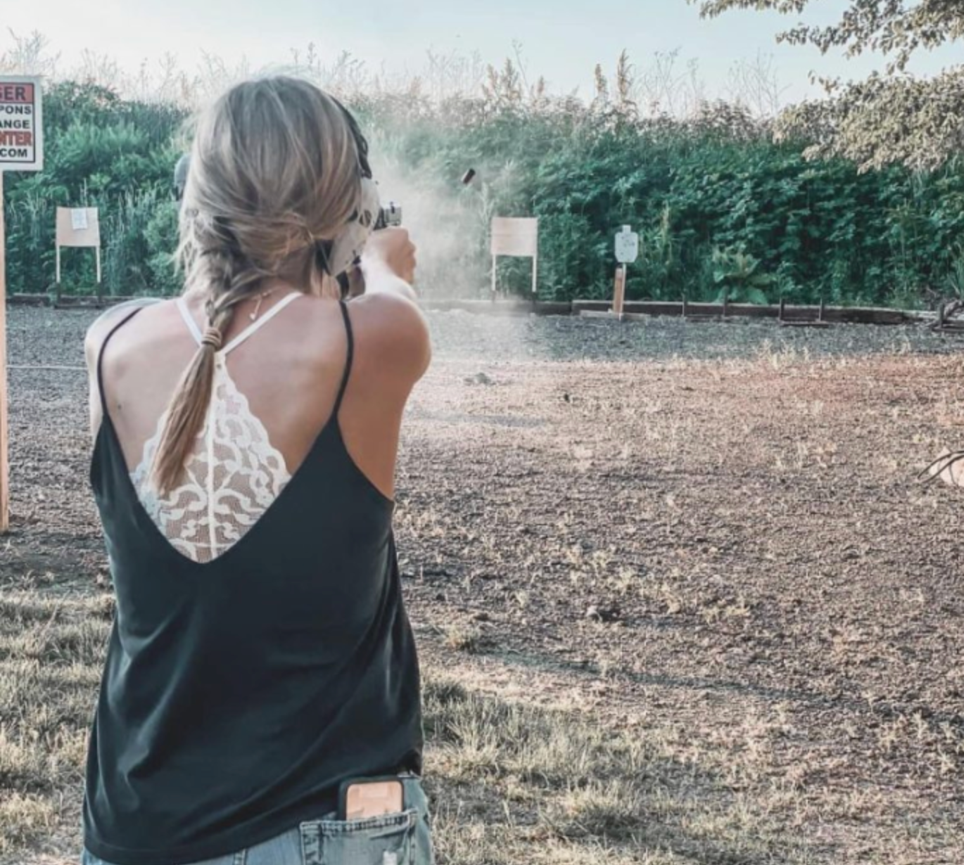 Woman practicing defensive handgun shooting at a firearms range