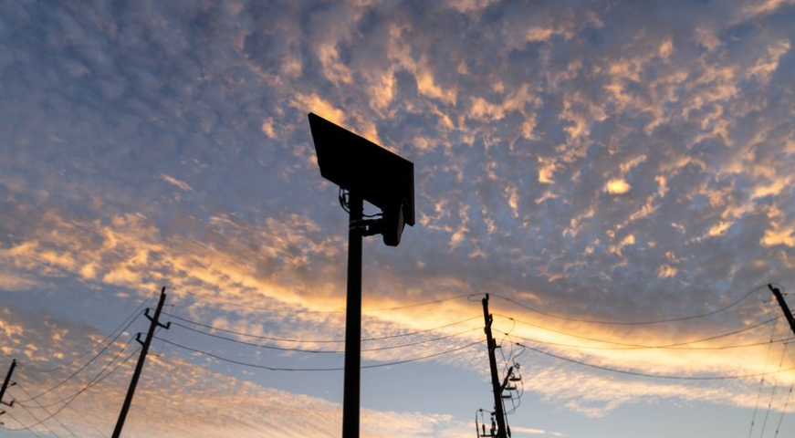 Flock Safety license plate reader mounted along a public road