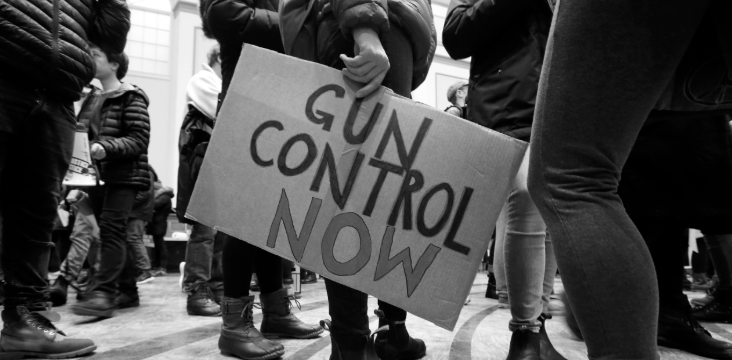 Protester holds a Gun Control Now sign during a demonstration